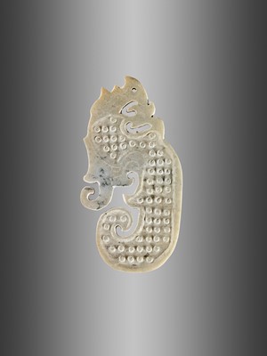 AN ARCHAISTIC CELADON JADE ‘DRAGON’ ORNAMENT