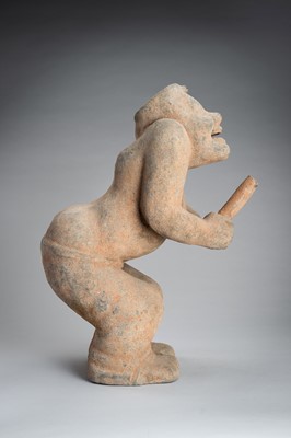 Lot 779 - A HAN-STYLE TERRACOTTA FIGURE OF A SQUATTING DRUMMER