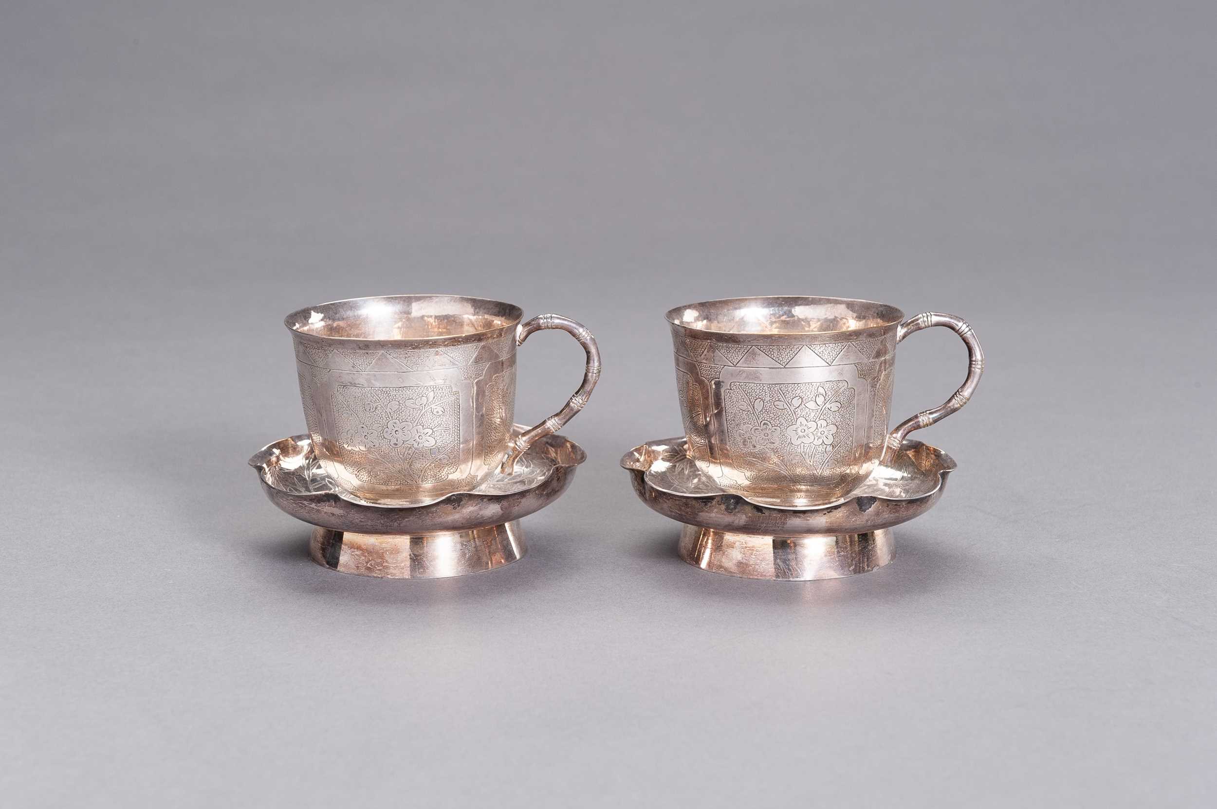 Lot 24 - A PAIR OF SILVER CUPS WITH MATCHING SAUCERS