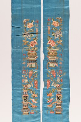 Lot 974 - A PAIR OF BLUE ‘AUSPICIOUS FLOWERS’ SILK SLEEVE BANDS, LATE QING DYNASTY