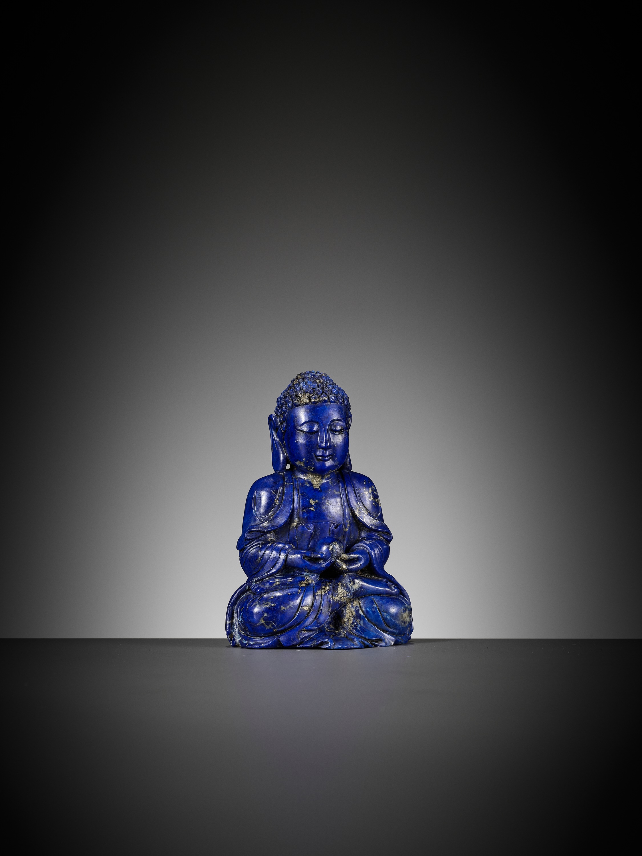 Lot 28 - A LAPIS LAZULI FIGURE OF BUDDHA, QING DYNASTY