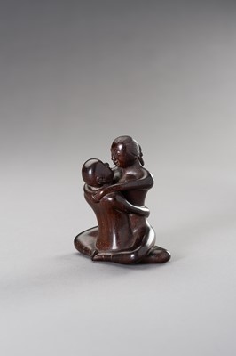 A ZITAN WOOD FIGURE OF A COUPLE IN EROTIC EMBRACE