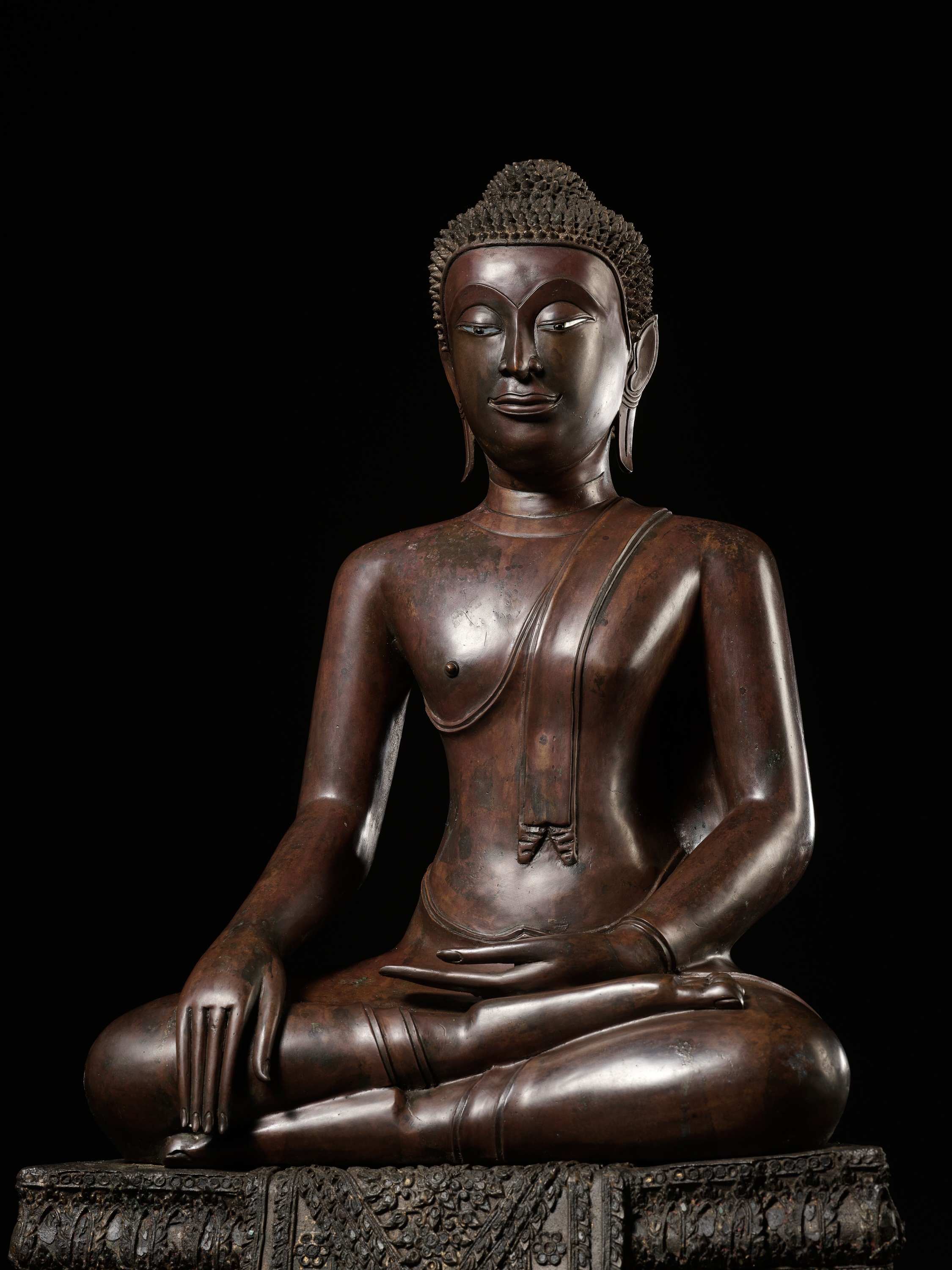 Lot 678 - A LARGE COPPER ALLOY FIGURE OF A SEATED