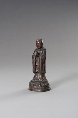 Lot 99 - A MINIATURE BRONZE FIGURE OF A MONK, EARLY QING DYNASTY