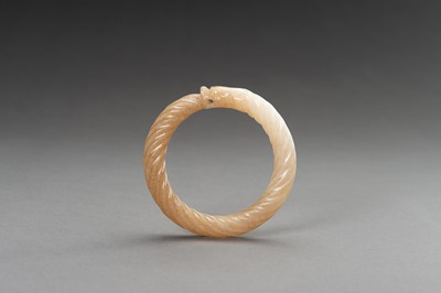 Lot 221 - A MOTTLED WHITE AND OCHRE ‘TWISTED ROPE’ JADE BANGLE, 1900s