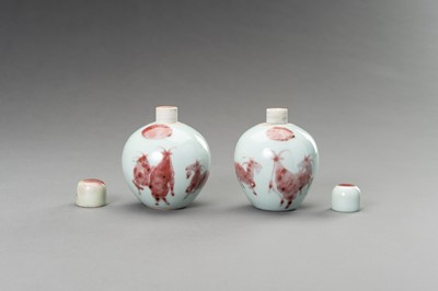 Lot 380 - A RARE PAIR OF COPPER-RED, LIDDED PORCELAIN JARLETS DEPICTING GOATS, 1900s