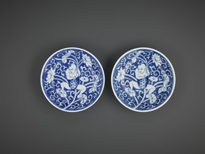 Lot 737 - A NEAR-PAIR OF BLUE AND WHITE ‘LOTUS BOY’ DISHES, KANGXI PERIOD