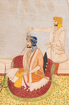 Lot 1323 - AN INDIAN MINIATURE PAINTING OF A RULER SMOKING A HUQQA