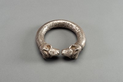 Lot 1361 - AN ACHAEMENID SILVER RAM-HEADED BRACELET