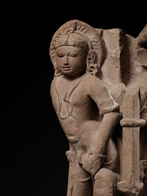Lot 700 - A PINK SANDSTONE ARCHITECTURAL CORNER ELEMENT WITH TWO MANIFESTATIONS OF SHIVA, CHANDELLA PERIOD