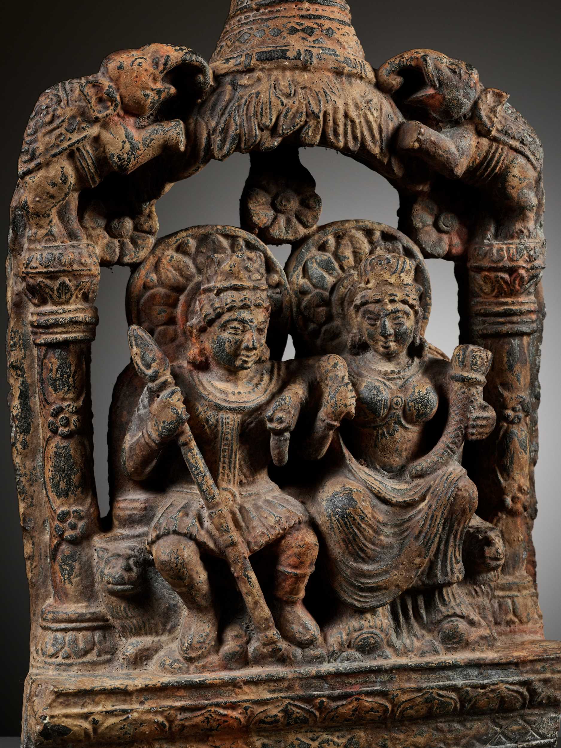 Lot 239 - A SANDSTONE GROUP DEPICTING HARITI AND PANCHIKA