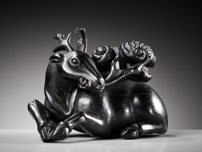Lot 21 - A ZITAN FIGURE OF A DEER HOLDING LINGZHI, 18TH CENTURY