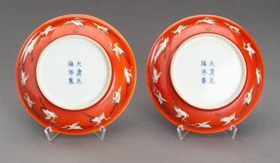 Lot 653 - A PAIR OF RED GROUND ‘BATS AND CRANES’ PORCELAIN SAUCER DISHES, GUANGXU MARK AND PROBABLY OF THE PERIOD