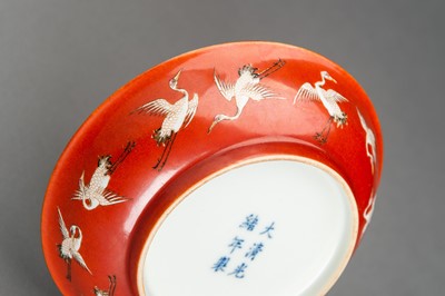 Lot 653 - A PAIR OF RED GROUND ‘BATS AND CRANES’ PORCELAIN SAUCER DISHES, GUANGXU MARK AND PROBABLY OF THE PERIOD