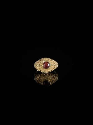 Lot 312 - A GARNET-SET GOLD ‘FLORAL’ PRIEST’S RING