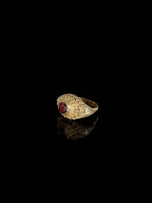 Lot 312 - A GARNET-SET GOLD ‘FLORAL’ PRIEST’S RING