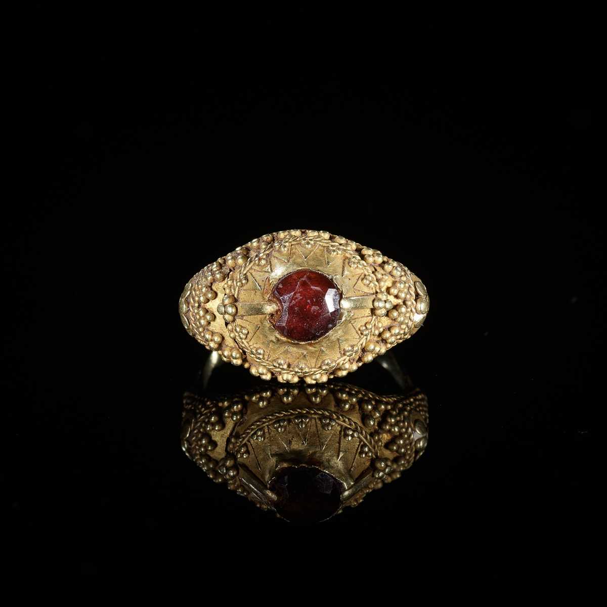 Lot 312 - A GARNET-SET GOLD ‘FLORAL’ PRIEST’S RING