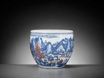 Lot 128 - A MASSIVE COPPER-RED AND UNDERGLAZE-BLUE ‘LANDSCAPE’ FISH BOWL, QING DYNASTY
