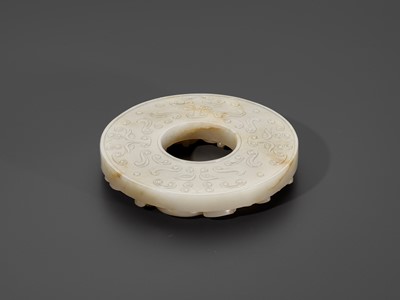 Lot 350 - A PALE CELADON AND RUSSET JADE ‘CHILONG’ DISC, BI, QING DYNASTY