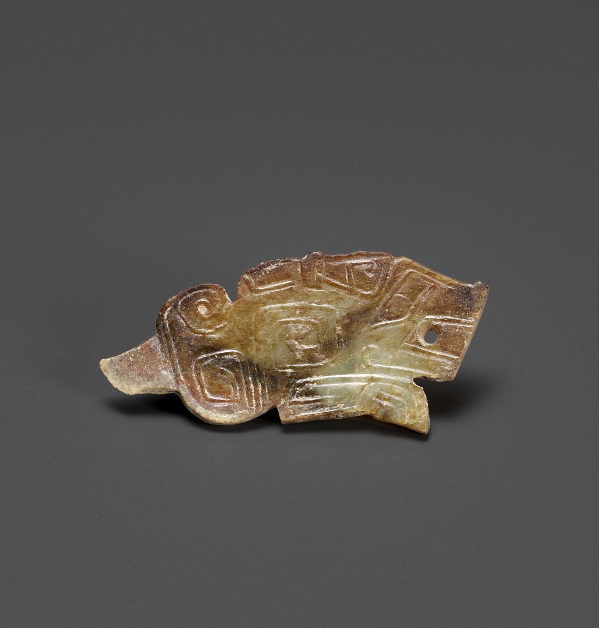 Lot 34 - A TIGER-FORM JADE PENDANT, LATE SHANG DYNASTY