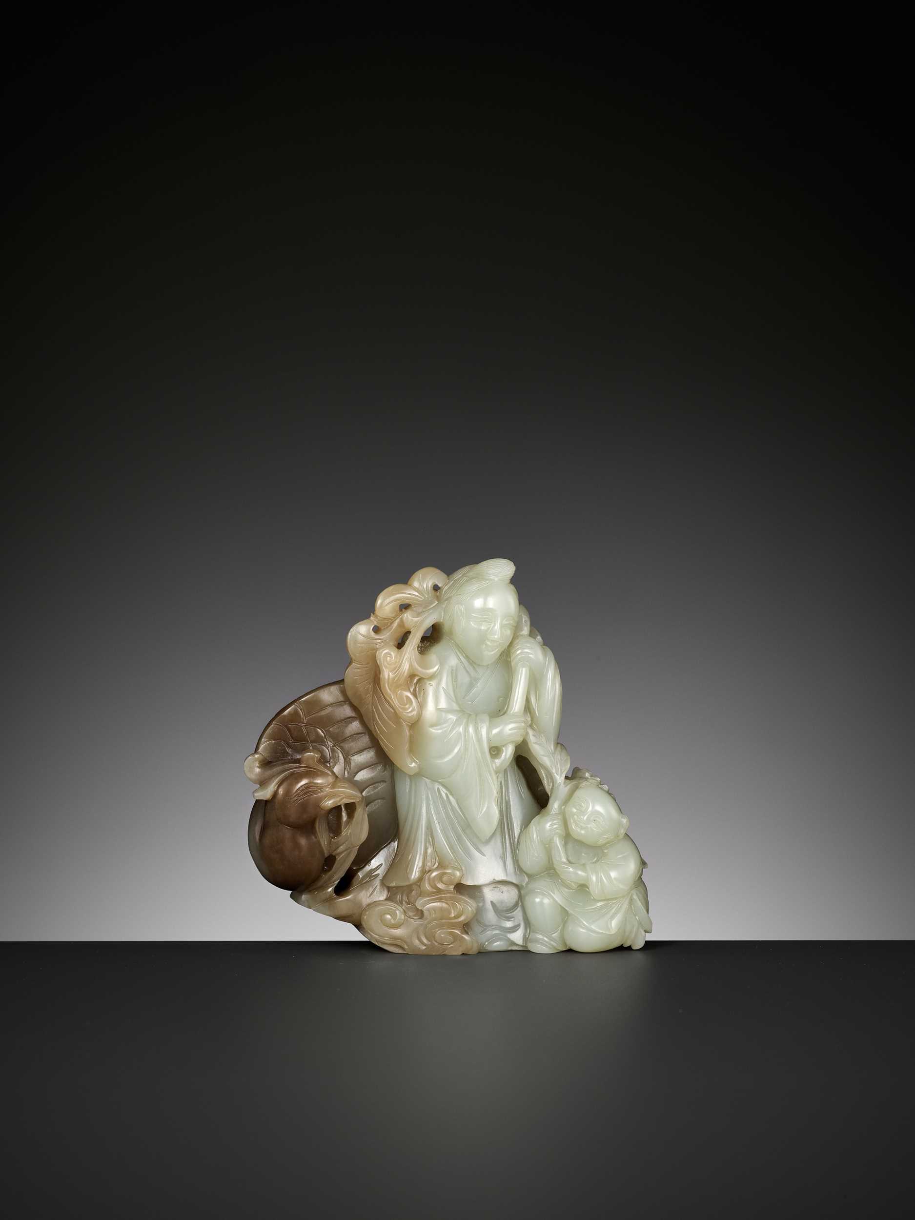 Lot 353 - A CELADON AND BROWN JADE ‘HE XIANGU, BOY AND