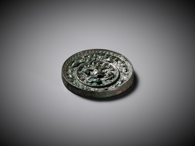 Lot 481 - A SILVERY BRONZE ‘LION AND GRAPEVINE’ MIRROR, TANG DYNASTY
