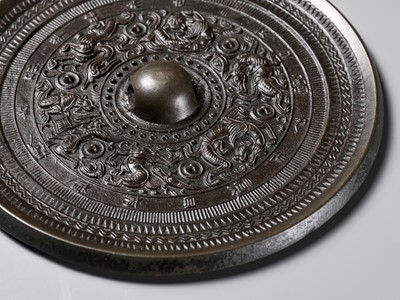 Lot 480 - A ‘MYTHICAL BEASTS’ BRONZE MIRROR, HAN DYNASTY