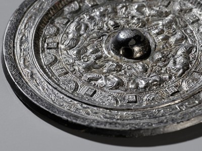 Lot 467 - A SILVERED BRONZE ‘DEITIES AND BEASTS’ MIRROR, HAN DYNASTY