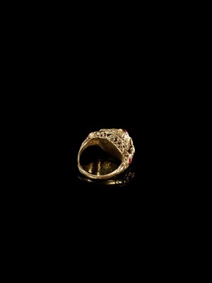 Lot 689 - A RUBY-SET GOLD ‘FLOWER AND BIRD’ PRIEST’S RING