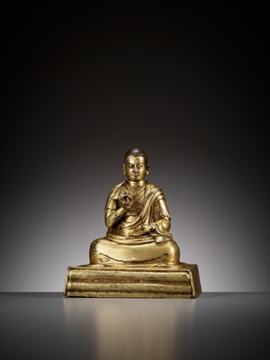 Lot 179 - AN INSCRIBED GILT BRONZE FIGURE OF A LAMA, 17TH-18TH CENTURY