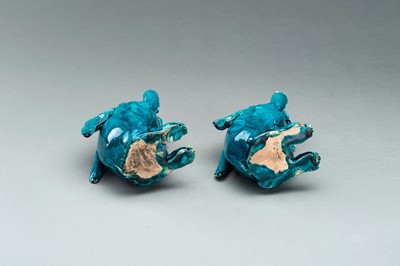 Lot 593 - A PAIR OF TURQUOISE GLAZED CERAMIC FIGURES OF RABBITS EATING BERRIES