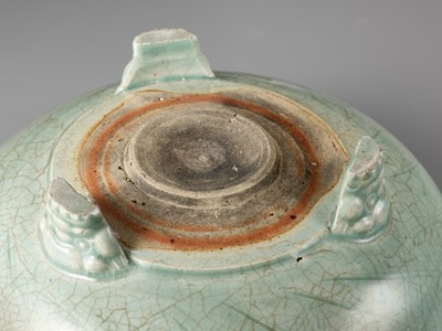 Lot 69 - A CARVED AND MOLDED LONGQUAN CELADON TRIPOD CENSER, MING DYNASTY