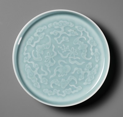 Lot 462 - A CARVED AND CELADON-GLAZED ‘THREE BATS’ DISH, QING DYNASTY