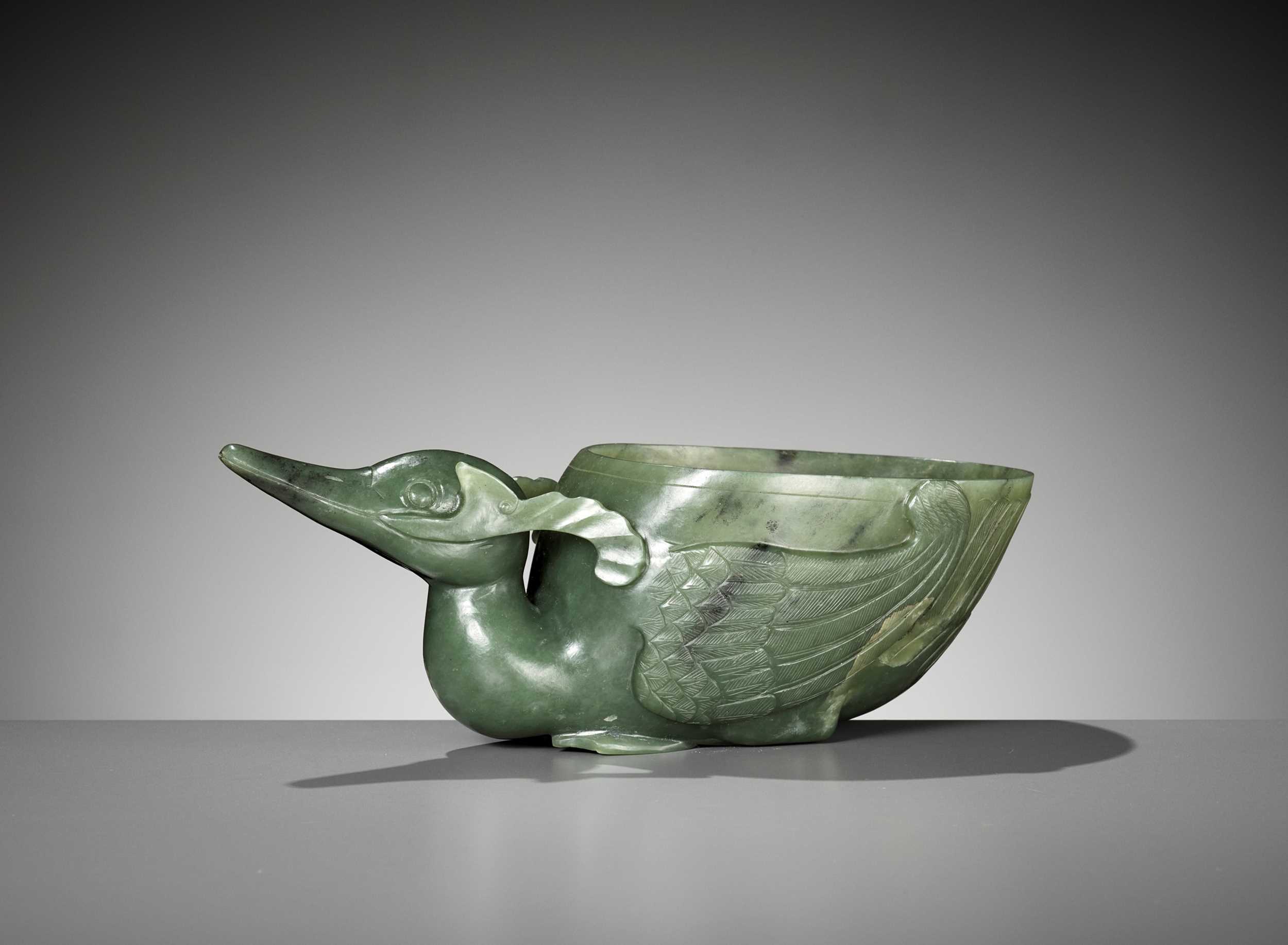 Lot 149 - A SPINACH GREEN JADE ‘DUCK’ LIBATION CUP, QING DYNASTY