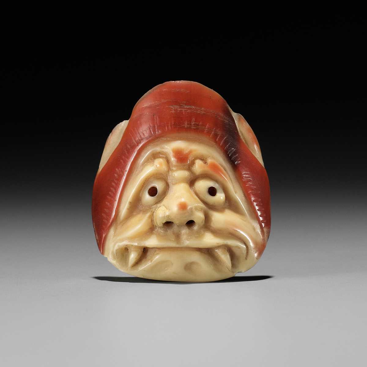 Lot 435 - A RARE HONEN (HORNBILL) MASK NETSUKE OF AN ONI, ATTRIBUTED TO JUGYOKU