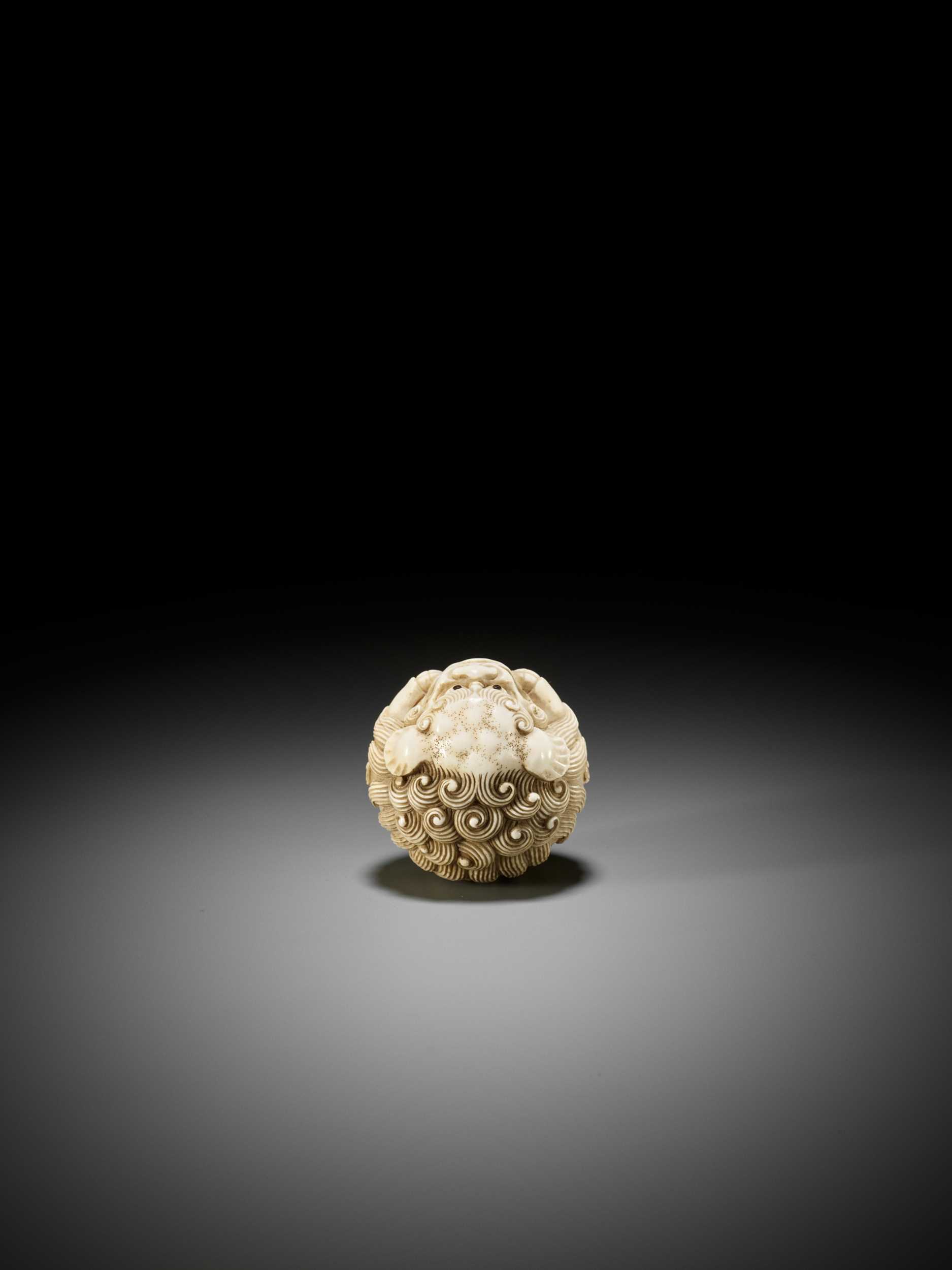 Lot 233 - AN IVORY NETSUKE OF A SHISHI BALL