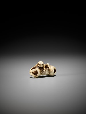 Lot 209 - A RARE IVORY NETSUKE OF AN ONI ON A KONGO (VAJRA)