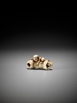 Lot 209 - A RARE IVORY NETSUKE OF AN ONI ON A KONGO (VAJRA)