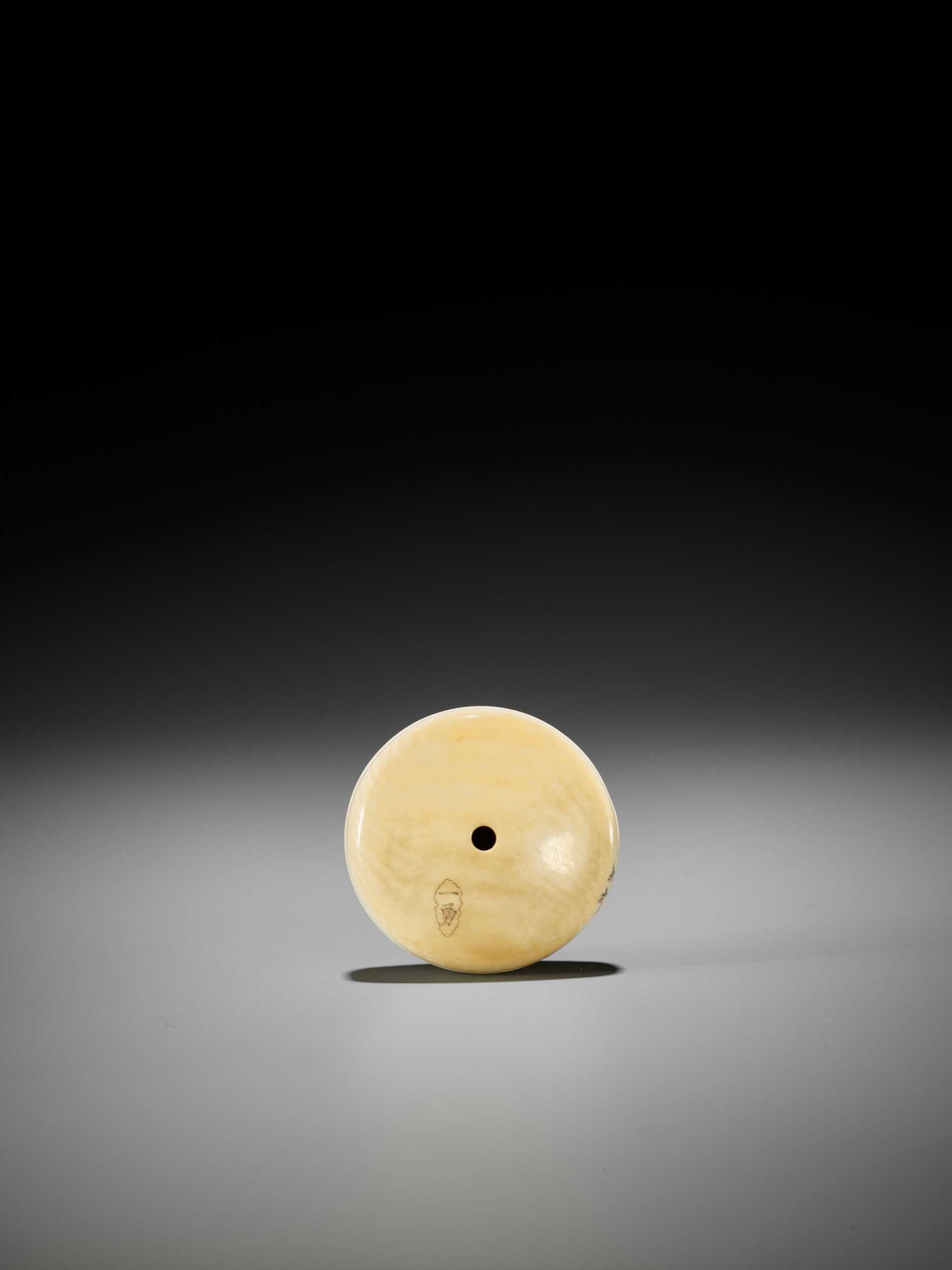 Lot 269 - ICHIYU: AN IVORY MANJU NETSUKE DEPICTING