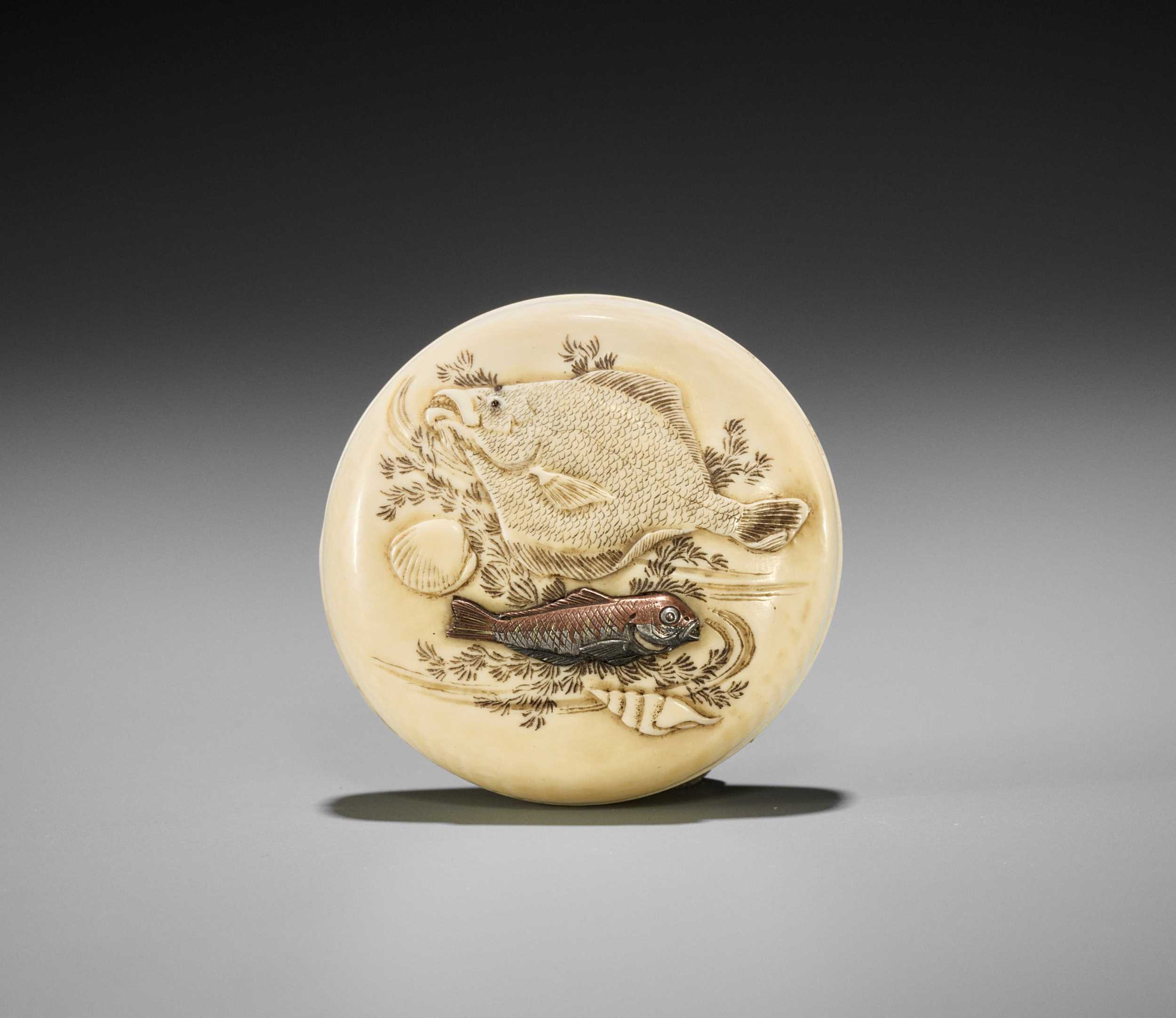 Lot 269 - ICHIYU: AN IVORY MANJU NETSUKE DEPICTING