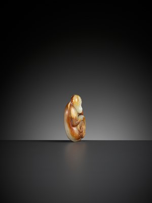 Lot 348 - A PALE CELADON AND RUSSET JADE FIGURE OF A MONKEY, QING DYNASTY
