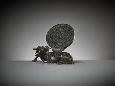 Lot 5 - A BRONZE ‘XINIU’ MIRROR STAND AND ‘LION AND GRAPEVINE’ MIRROR, MING AND TANG DYNASTY