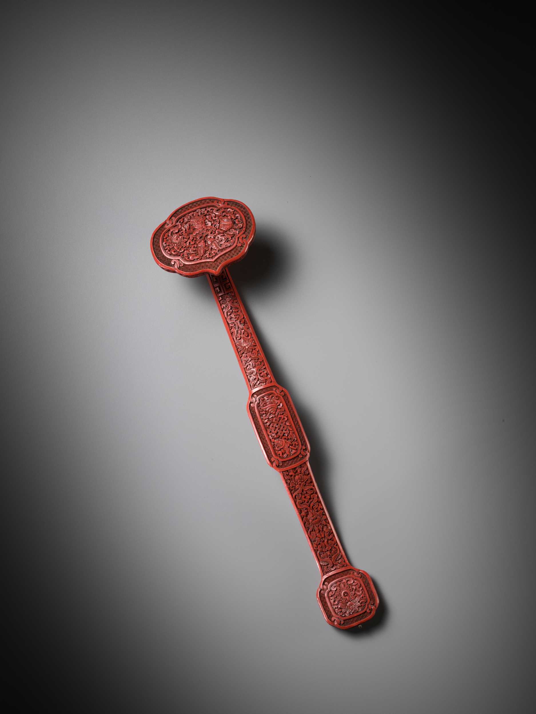 Lot 11 - A CARVED CINNABAR LACQUER ‘BAJIXIANG’ RUYI SCEPTER, QING DYNASTY