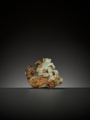 Lot 337 - A CELADON AND RUSSET JADE FIGURE OF A BOY RIDING A DRAGON-CARP, 17TH-18TH CENTURY