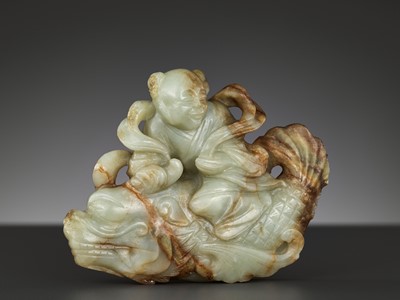A CELADON AND RUSSET JADE FIGURE OF A BOY RIDING A DRAGON-CARP, 17TH-18TH CENTURY