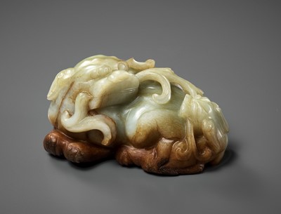 Lot 161 - A CELADON AND RUSSET JADE ‘BUDDHIST LION AND CUB’ GROUP, 17TH CENTURY