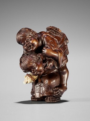 Lot 1572 - SEIHO: A FINE STAINED BOXWOOD NETSUKE OF CHILDREN AT PLAY