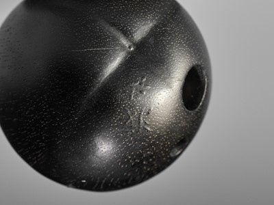 Lot 92 - SEIYODO TOMIHARU: A SUPERB EBONY WOOD NETSUKE OF A PERSIMMON WITH METAL-APPLIED ANT