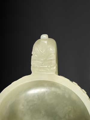 Lot 329 - A PALE CELADON TWO-HANDLED JADE CUP, MING DYNASTY