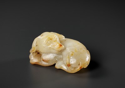 Lot 335 - A PALE CELADON AND RUSSET JADE FIGURE OF A DOG, 17TH-18TH CENTURY